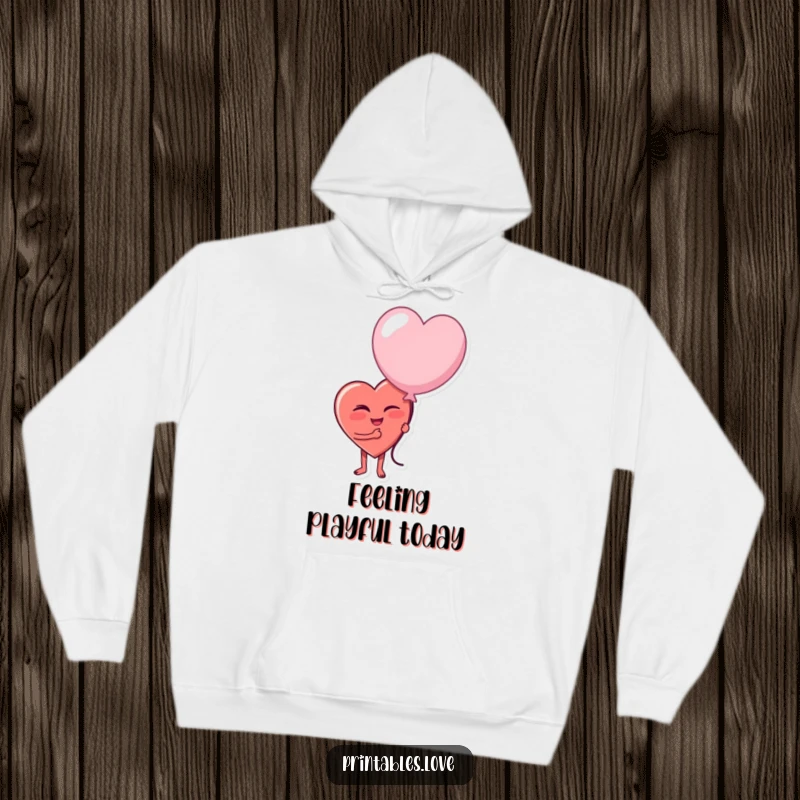 Funny hoodie featuring a heart character giving a playful wink and holding a slightly deflated balloon, embracing the absurdity of life.