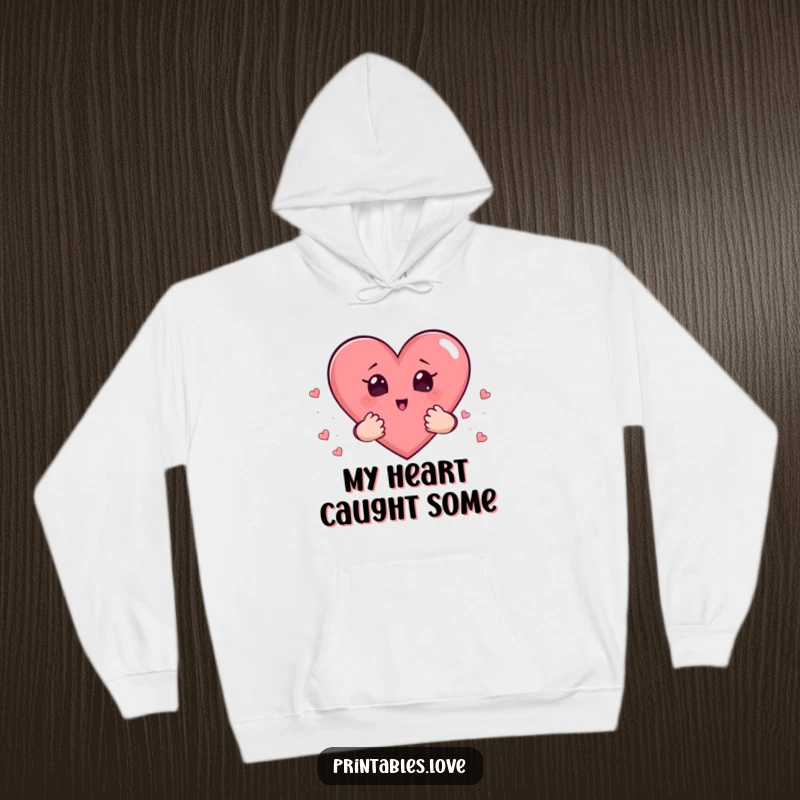 Funny hoodie with a heart character holding smaller hearts in its tiny hands, its face a picture of surprise.