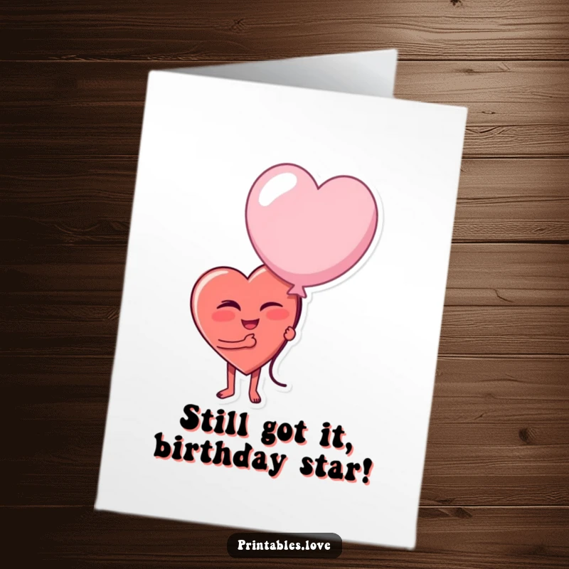 Funny Free Printable Birthday Card: A heart character winks playfully while holding a large, somewhat deflated party balloon.