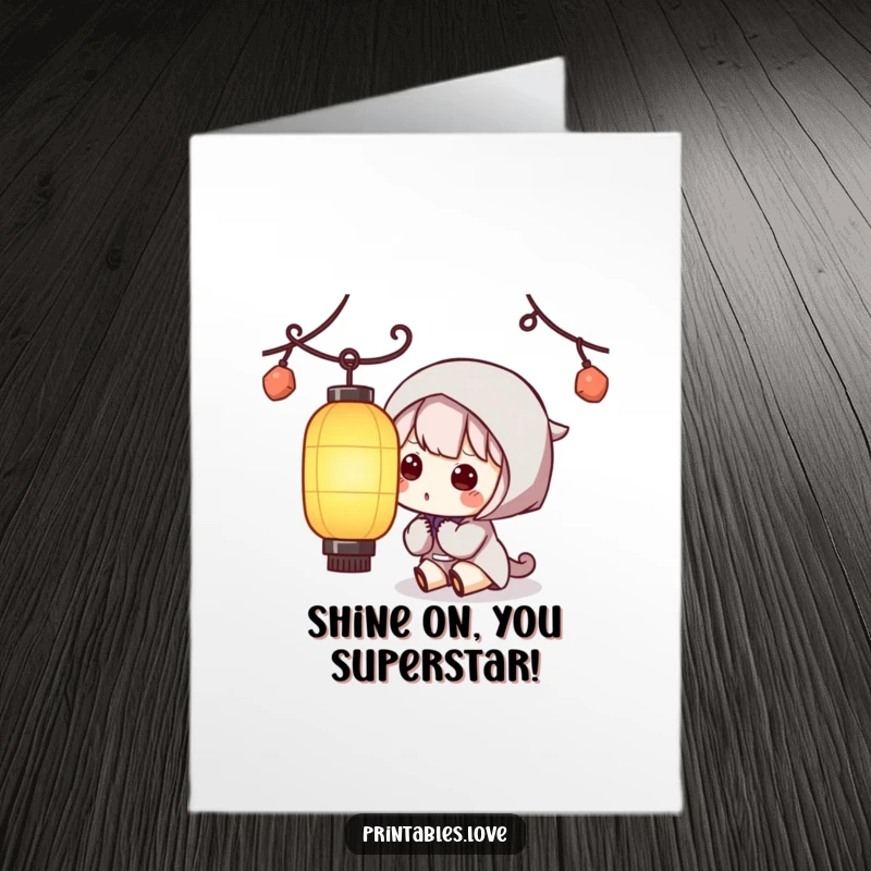Funny free printable congratulations card showing a Kawaii character looking with curiosity at a bright paper lantern.