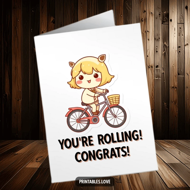 Free Printable Congratulations Card: A Kawaii character joyfully cycling on a bike with a decorated basket.